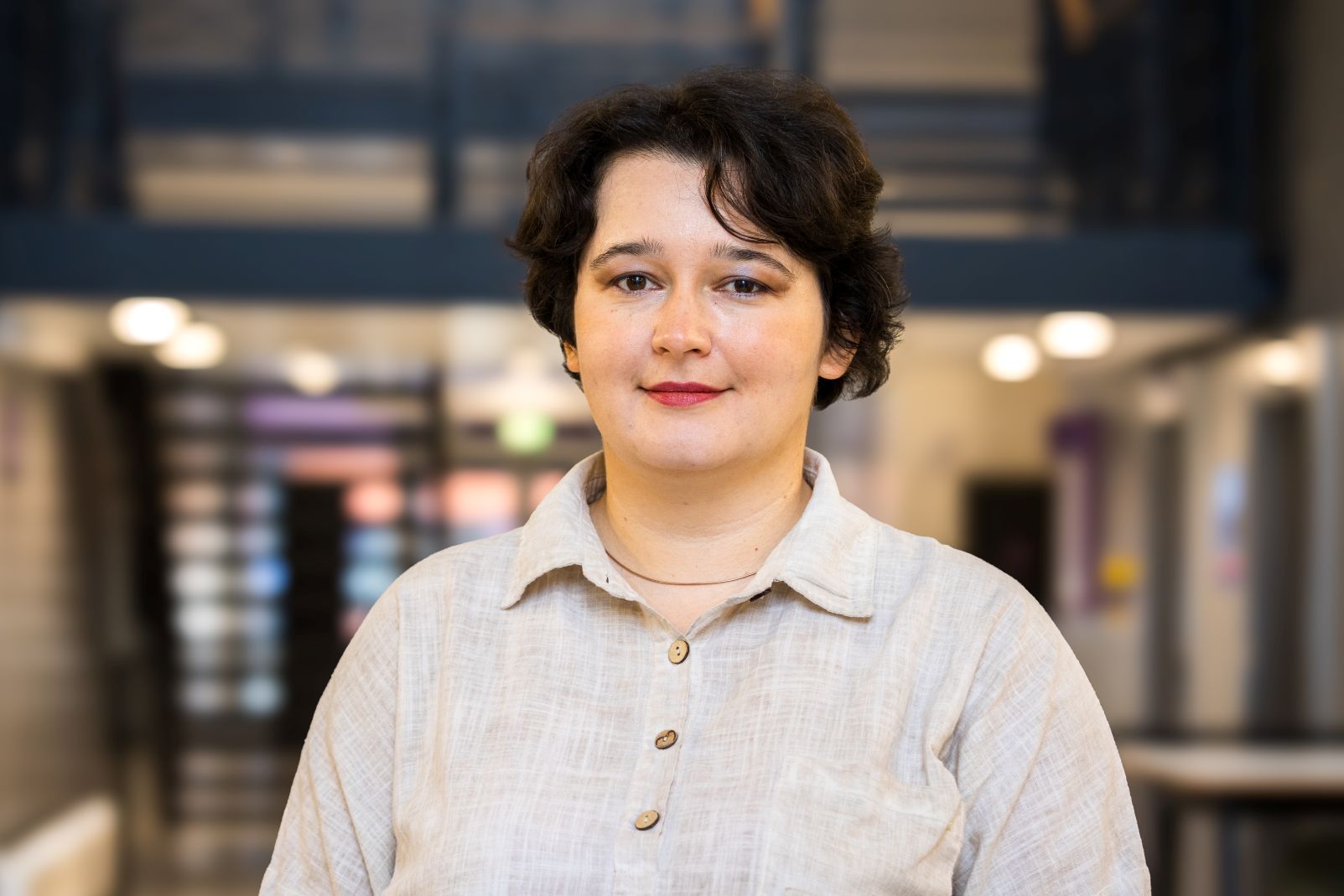 Portrait image of a female academic with dark brown short hair, wearing a casual shirt.